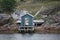 A blue shed at water\'s edge