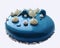 Blue shiny glazed mousse cake with white chocolate ganache topping