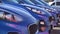 Blue shiny sports car business lot row parking