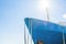 Blue ship`s nose on a blue sky background. Ship`s ropes. Bright sun above the deck.