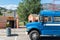 Blue shuttle bus parked outside Coyote Cruises River Float by the Penticton River Channel