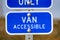 Blue sign with a Van Accessible text on a parking area for handicapped people