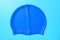 blue silicone swimming cap on a blue background