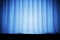 Blue silk curtains for theater and cinema spotlit light in the center. 3d rendering