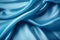 Blue silk fabric texture background. Beautiful blue satin textile texture with folds. Smooth elegant abstract background