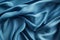 Blue silk fabric texture background. Beautiful blue satin textile texture with folds. Smooth elegant abstract background