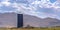 Blue silo and barn on a farm overlooking mountain