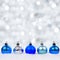 Blue and silver Christmas ornaments in snow with twinkling background