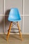 Blue simple stylish chair over grey wall