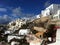 Blue skies above Oia and the whitewashed houses hugging the slope