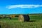 Blue sky above a hay field