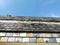 Blue sky against tiles looking up with wisps of cloud