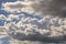 Blue sky background with big white tiny stratus cirrus striped clouds