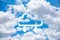 Blue sky background with clouds. and there is a cloud icon inserted with an arrow pointing up and down. is a network concept