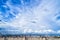 Blue sky background with tiny clouds and cityscape