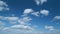 Blue sky background with tiny stratocumulus and cumulus fluffy clouds. Concepts of weather forecast, vacations