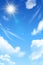Blue sky background with white clouds and sun. Realstic cloudy effect.