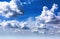 blue sky background with white cumulus clouds