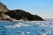 Blue sky, birds, sea waves, rocky shore on the Black sea in Crimea.