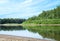 Blue sky on a calm summer day. Bend of the river in Siberia  forest near water