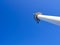 Blue sky clear behind the radar tower outside a large port with copyspace