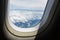 Blue sky and cloud with looking out an airplanes porthole window during a flight , image using for sky and interior