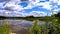 Blue sky with clouds, lake. Real time