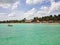 Blue sky and clouds over a beautiful tropical beach with green palm trees and pacific crystal turquoise water. Cayo Guilermo, Cuba