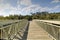 Blue sky and clouds over a bridge that crosses Henderson Creek, which runs through Rookery Bay