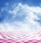 Blue sky with clouds reflected in the pink abstract fantasy checkerboard floor