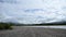 Blue sky and clouds on sunny summer day with flowing river flow timelapse