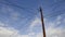 Blue sky and clouds with telephone pole