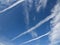 The blue sky with contrails of planes