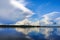 Blue sky with Cumulus clouds over the forest at the Lake Ladoga
