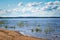 Blue sky with Cumulus clouds over the Lake Ladoga shore