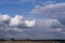 Blue sky with dark, rainy clouds .