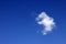 Blue sky with fluffy white cloud. Small cumulus cloud on blue sky in the fine weather day.