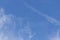 In a blue sky, a glider stretches a motor airplane