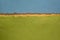 Blue sky and green fields abstract landscape created with handmade Indian paper