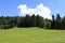 Blue sky and green meadow in a natural landscape of Folgaria upland