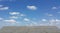 Blue sky and grey dry soil surface with cracks , Soil drought cracks texture background