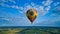 Blue sky and multiple clouds and a hot air balloon