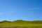 Blue Sky Over Green Hills in Badlands