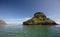 Blue sky over Mokolii island [also known as Chinamans Hat] as seen from the water on the North Shore of Oahu Hawaii USA