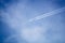 blue sky with plane in the clouds