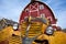 Blue sky, red barn, yellow truck.