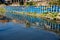 The blue sky is reflected in the black water of the Sadarghat Launch Terminal