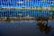 The blue sky is reflected in the black water of the Sadarghat Launch Terminal