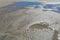 Blue sky reflected in shallow tide pools on a sandy beach, Tybee Island Georgia USA, creative copy space