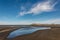 Blue sky reflecting in pool on Whatipu beach